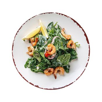 Plate of gourmet shrimp salad with spinach