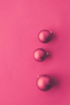 Christmas baubles on pink flatlay backdrop, luxury winter holiday card background