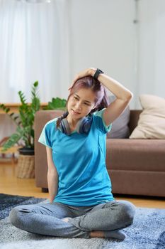 stress relief, muscle relaxation, breathing exercises, exercise, meditation, portrait of Young Asian woman relaxing her body from office work by practicing yoga by watching online tutorials.