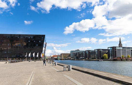 View of the canal in the central part of Copenhagen and modern building of the royal library in Copenhagen - Black Diamont.