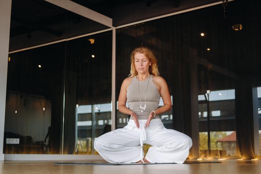 The girl does yoga and is in a state of meditation. The concept of a healthy lifestyle