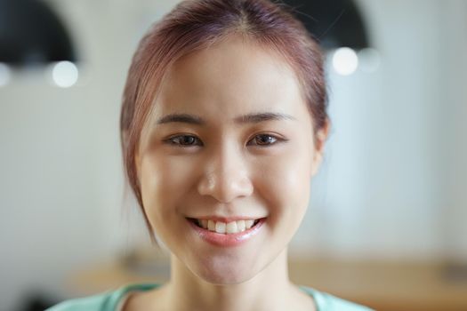 Portrait of a young Asian woman showing a happiness smiling face
