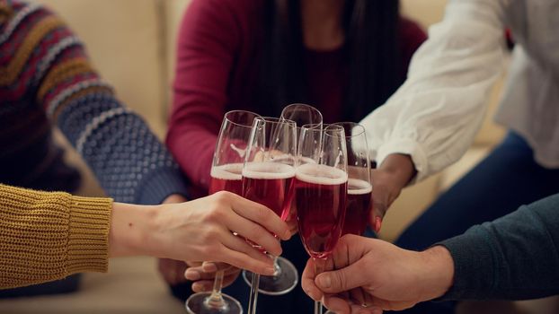 Group of people clinking glasses of wine to celebrate xmas holiday