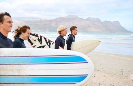 Surfing is beyond invigorating. Young surfers excited about hitting the awesome waves.