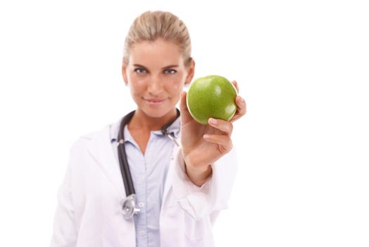 Presenting the healthy alternative. A beautiful young doctor holding an apple.