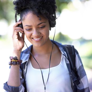 Feeling the beat. A young woman with headphones around her neck.
