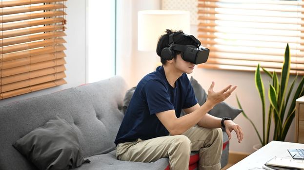 Man playing simulation game with virtual reality headset. Future technology concept