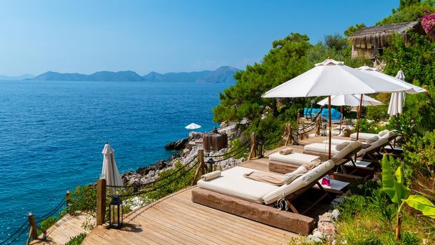 beach beds with white umbrellas looking out over the ocean in Turkey