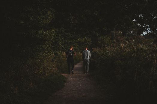 Two guys walking on forest