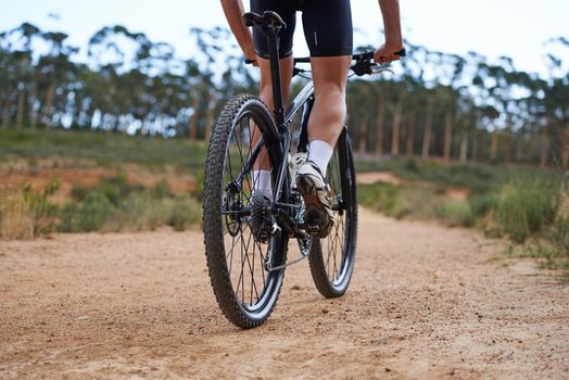 Mountain biking is addictive. Cropped view of a cyclist exploring outdoor terrain on his bike.