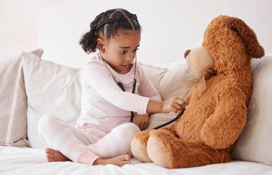 Stethoscope, teddy bear and girl in bed for heartbeat in hospital doctor or nurse game play of love, support and care. Young child learning, test and check medical heartbeat health exam on baby toy