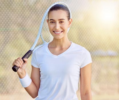 Portrait of tennis woman at the tennis court with a smile on her face. Young female doing sports, having fun and ready for a game with tennis racket. Fitness, motivation and smiling tennis player