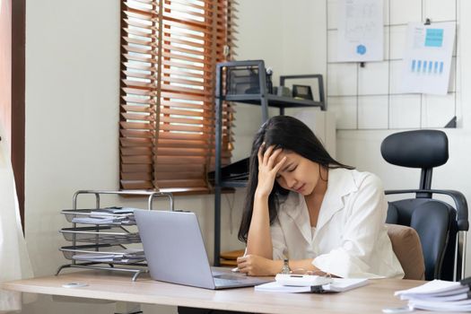 Tired business accountant woman feel headache. stressed working woman at business desk in a business office
