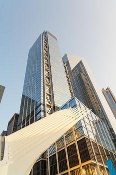 View of the tower of a skyscraper made of glass and concrete from the Cortlandt metro station