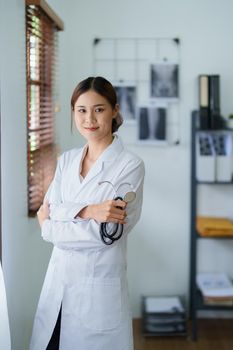 Portrait of an Asian female doctor smiling happily holding a stethoscope after a break from work