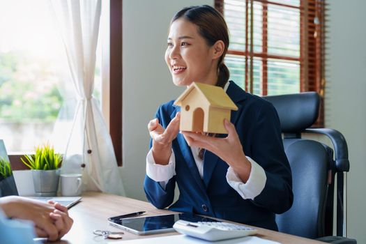 Portrait of a real estate agent or bank officer, the lending department quotes the interest on the loan to the customer to assess the risk of investing in a home