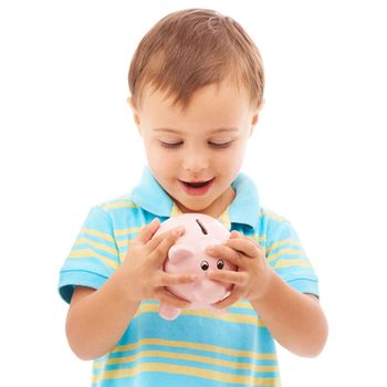 It feels so full. Studio shot of a young boy looking at a piggy bank isolated on white.