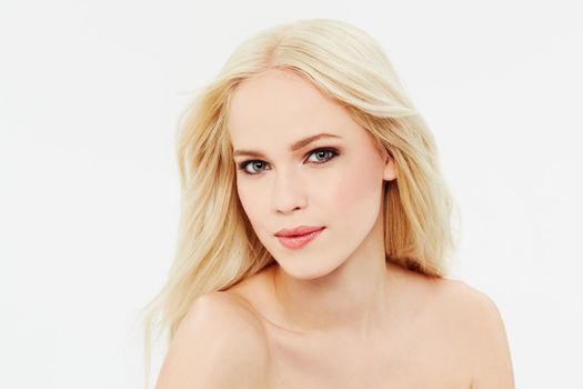 Soft, flawless skin. Portrait of a beautiful blonde against a white background.