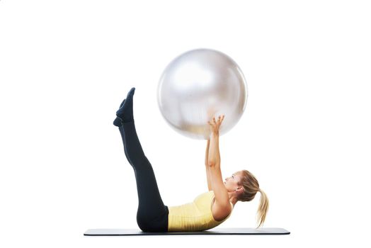 Her routine works out every part of her body. a female lifting an exercise ball up.