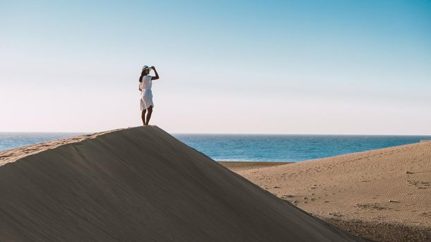 young woman at the dessert of Maspalomas sand dunes Gran Canaria during vacation Canary Islands