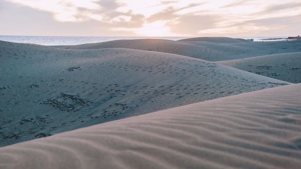 Sand dunes beach of Maspalomas Gran Canaria during sunrise