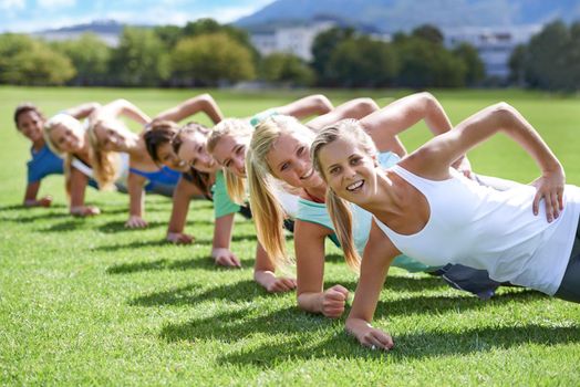 Exercise 101 Be active, get sweaty, feel great, repeat.A group of young women working out together on a sportsfield.