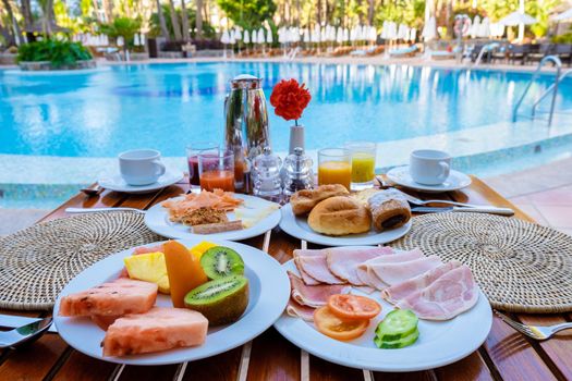 colorful breakfast by a pool of a luxury resort