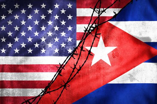 Grunge flags of USA and Cuba divided by barb wire illustration