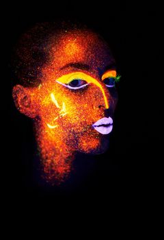 Neon kiss. A young woman with with neon paint on her face posing.