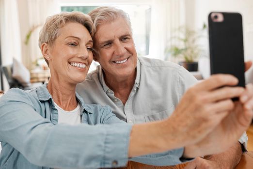 Senior couple taking selfie with phone, smile in love with 5g and technology for social media in marriage at house. Happy, married and smiling man and woman streaming, communication or video call