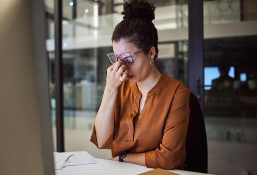 Stress, burnout and woman with a headache tired from working overtime at her office desk due to paperwork deadlines. fatigue, mental health and overwhelmed administrator frustrated with a migraine