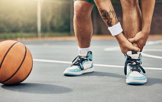 Basketball, ankle in pain and injury from sports or accident on the court in a fitness game or training match outdoors. Athlete suffering with muscle inflammation, hurt leg joint or a broken bone