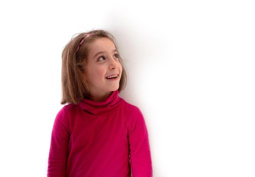 Little child girl smiling and looking up on white background