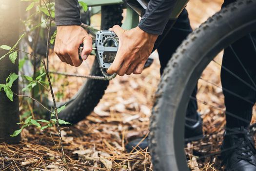 Cycling, maintenance and hands of man with mountain bike fix, service or repair wheel gear, chain or tire equipment. Nature race, adventure journey and person working on bicycle for travel in forest