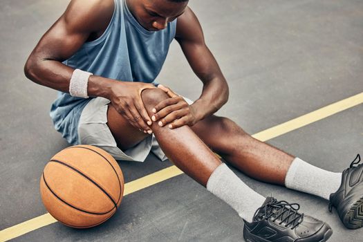 Fitness, basketball knee injury or pain while on basketball court holding leg in exercise, training or sport workout. Professional athlete, health or sports man with accident in street game or event