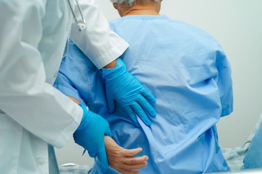 Doctor examine and treat asian elderly patient muscle back pain problem and physical therapy in hospital.