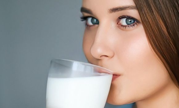Diet and wellness, young woman drinking milk or protein shake cocktail