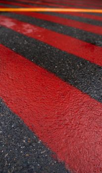 Road marking for fire tracks parking. abstract background of red and white markings for fire fighting equipment on wet pavement