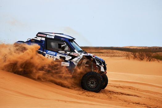 Women's crew at the rally. Sports car gets over the difficult part of the route during the Rally raid THE GOLD OF KAGAN-2021. 26.04.2021 Astrakhan, Russia