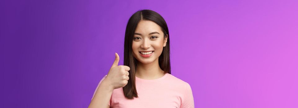 Friendly good-looking supportive asian female friend encourage you keep going, nice work, satisfied good job, smiling approval, show thumb-up gesture, grinning accepting perfect choice