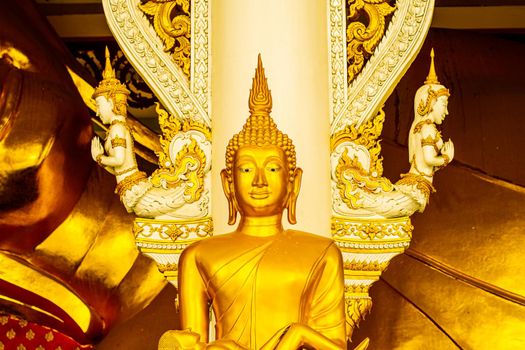 close up Golden buddha statue in religiuus asian temple decoration with ancient worship angel