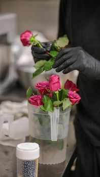 chef selecting roses for a cake topping