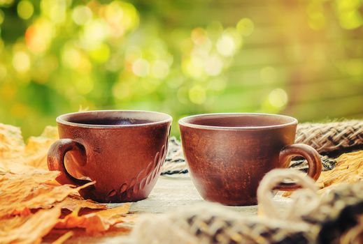 A cup of tea and a cozy autumn background. Selective focus.