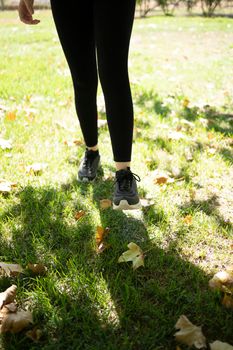 young woman wearing sport shoes jogging in the park. Healthy life and sports concept