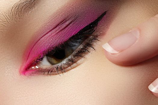 Closeup Macro of Woman Face with Pink Eyes Make-up. Fashion Celebrate Makeup. Beautiful Bright Magenta Make-up