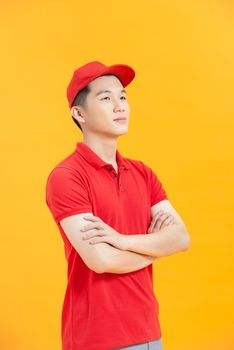 Portrait of attractive content virile cheerful guy mailman folded arms isolated over vibrant yellow color background