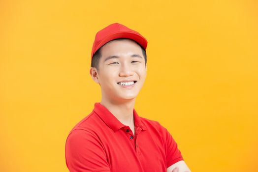 Portrait of attractive content virile cheerful guy mailman folded arms isolated over vibrant yellow color background