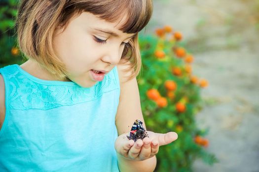 Child with a butterfly. Selective focus. nature.