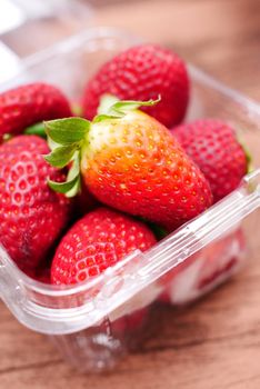Ripe Red Strawberries in a plastic packet on table