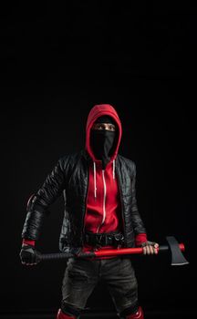 a man in a Balaclava and hoodie with an axe the image of a Protestant